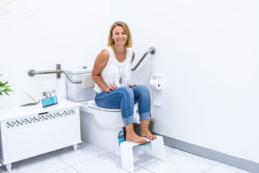 Using a toilet foot stool for the proper squat position on the western pedestal toilet